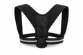 Black adjustable posture corrector with shoulder straps and upper back support